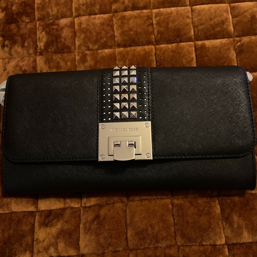 Michael Kors Black leather Tina clutch purse with silver studded accents.